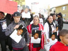 Lovelle Mixon's mother and wife among the mourners during a vigil on March 25