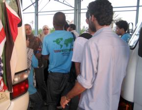 Members of the Viva Palestina delegation surround their bus to prevent Egyptian officials from taking them