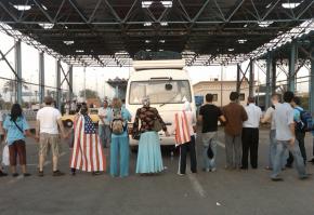 Members of the Viva Palestina delegation form a human blockade in front of their bus to prevent it from being moved