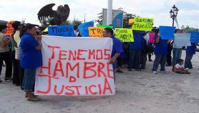 TRW workers protest with a banner that reads: "We are hungry for justice"