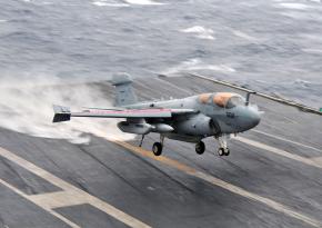 A U.S. Navy jet touches down on an aircraft carrier