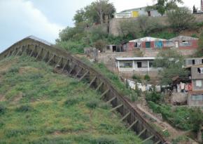 Near the main border crossing in Nogales, Ariz., the border fence leaps out from the surrounding landscape