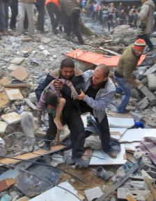 Gaza residents carry a child away from the site of an Israeli strike