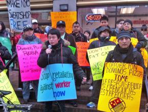 Domino's workers and their supporters picket in front of a franchise in Manhattan