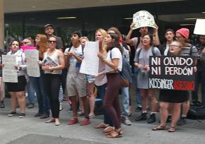 Demonstrators gathered to protest a conference honoring Henry Kissinger