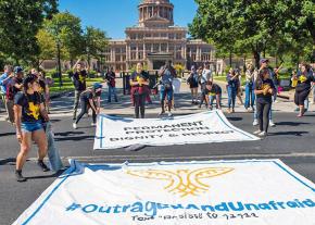 DACA recipients and solidarity activists unfurl banners for a sit-in at the Texas Capitol building