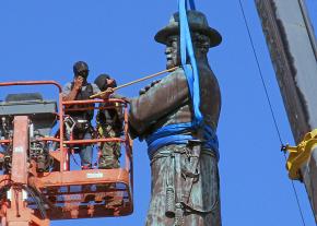 Workers remove a statue of Confederate General Robert E. Lee from a New Orleans square