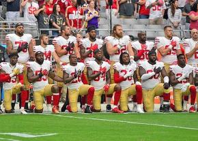 Members of the San Francisco 49ers take a knee against racism