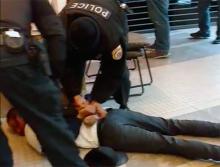 Loyola University police officers pin down a socialist student activist